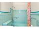 Retro bathroom with light teal tile and shower at 6890 Dr Martin Luther King Jr S St, St Petersburg, FL 33705