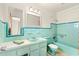 Retro bathroom with teal tile and modern vanity at 6890 Dr Martin Luther King Jr S St, St Petersburg, FL 33705