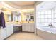 Elegant bathroom with a large soaking tub, dual sinks, and updated vanity at 72 Norman St, Port Charlotte, FL 33954