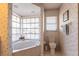Bathroom with marble bathtub, toilet, and floral wallpaper at 72 Norman St, Port Charlotte, FL 33954