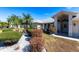 Well-maintained front yard with lush landscaping and a paved driveway at 72 Norman St, Port Charlotte, FL 33954