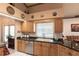 Well-equipped kitchen with wood cabinets and granite countertops at 72 Norman St, Port Charlotte, FL 33954