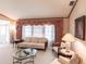 Living room with light walls, large windows, and comfortable furniture at 72 Norman St, Port Charlotte, FL 33954