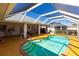 Relaxing pool area with covered patio and outdoor seating at 72 Norman St, Port Charlotte, FL 33954