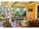 Relaxing back patio with wicker furniture and colorful tile flooring at 728 Wood St, Dunedin, FL 34698