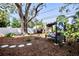 Relaxing backyard with a swing bench under a large oak tree at 728 Wood St, Dunedin, FL 34698
