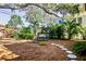 Peaceful backyard with a swing and stone pathway at 728 Wood St, Dunedin, FL 34698