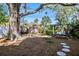 Spacious backyard with a swing and mature oak tree at 728 Wood St, Dunedin, FL 34698