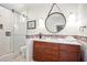 Spa-like bathroom with a large mirror, double vanity, and walk-in shower at 728 Wood St, Dunedin, FL 34698