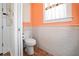 Small but well-appointed bathroom with subway tile and coral walls at 728 Wood St, Dunedin, FL 34698