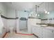 Elegant bathroom with a walk-in shower, double vanity, and mosaic tile accents at 728 Wood St, Dunedin, FL 34698