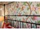 Main bedroom features floral wallpaper and black metal bed frame at 728 Wood St, Dunedin, FL 34698