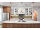 Modern kitchen with copper pendant lights, white cabinets, and a quartz island at 728 Wood St, Dunedin, FL 34698