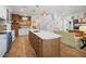 Open kitchen boasts an island, stainless steel appliances, and stylish cabinetry at 728 Wood St, Dunedin, FL 34698