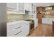 Modern kitchen with white cabinets, quartz countertops, and stainless steel appliances at 728 Wood St, Dunedin, FL 34698