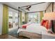 Main bedroom with king bed, French doors to patio, and green curtains at 728 Wood St, Dunedin, FL 34698