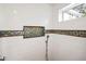 Shower with mosaic tile details and a window for natural light at 728 Wood St, Dunedin, FL 34698
