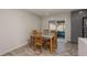 Bright dining area with glass-top table and access to patio at 735 Bonnie Blvd, Palm Harbor, FL 34684