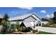 Home exterior showcasing attached garage and well-manicured landscaping at 735 Bonnie Blvd, Palm Harbor, FL 34684