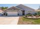 Attractive single-story home with a two-car garage and landscaped front yard at 735 Bonnie Blvd, Palm Harbor, FL 34684