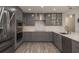 Renovated kitchen with gray cabinets, quartz countertops, and stainless steel appliances at 735 Bonnie Blvd, Palm Harbor, FL 34684