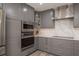 Modern kitchen with gray cabinetry, stainless steel appliances and quartz countertops at 735 Bonnie Blvd, Palm Harbor, FL 34684