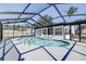 Kidney-shaped swimming pool with a screened enclosure at 9750 68Th N St, Pinellas Park, FL 33782