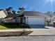 House exterior with a white garage door and front yard at 10820 Livingston Dr, New Port Richey, FL 34654