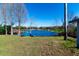 Peaceful backyard oasis with a pond view and lush green grass at 11416 Pine Forest Dr, New Port Richey, FL 34654