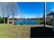 Peaceful backyard oasis with a pond view and lush green grass at 11416 Pine Forest Dr, New Port Richey, FL 34654