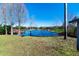 Peaceful backyard oasis with a pond view and lush green grass at 11416 Pine Forest Dr, New Port Richey, FL 34654