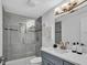 Modern bathroom with gray tile shower and updated vanity at 11416 Pine Forest Dr, New Port Richey, FL 34654