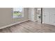 Bedroom with hardwood floors, water view, and additional closet space at 11416 Pine Forest Dr, New Port Richey, FL 34654