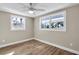 Bright bedroom featuring hardwood floors and multiple windows at 11416 Pine Forest Dr, New Port Richey, FL 34654