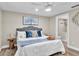 Spacious bedroom with king bed, ensuite bathroom, and ceiling fan at 11416 Pine Forest Dr, New Port Richey, FL 34654