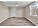 Well-lit bedroom with hardwood floors and exterior access at 11416 Pine Forest Dr, New Port Richey, FL 34654