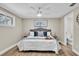 Comfortable bedroom with a king-size bed and ceiling fan at 11416 Pine Forest Dr, New Port Richey, FL 34654