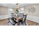 Elegant dining room with a wooden table and stylish chandelier at 11416 Pine Forest Dr, New Port Richey, FL 34654