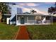 Charming single story home with a covered porch and well-manicured lawn at 11416 Pine Forest Dr, New Port Richey, FL 34654