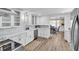 Modern kitchen with white cabinets, stainless steel appliances, and a farmhouse sink at 11416 Pine Forest Dr, New Port Richey, FL 34654