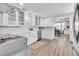 Modern kitchen with white shaker cabinets, a farmhouse sink, and stainless steel appliances at 11416 Pine Forest Dr, New Port Richey, FL 34654