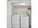 Convenient laundry room with washer, dryer, and ample storage at 11416 Pine Forest Dr, New Port Richey, FL 34654