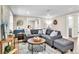 Open living area with a spacious gray sectional sofa and wood coffee table at 11416 Pine Forest Dr, New Port Richey, FL 34654