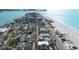 Aerial view of a beach town with many houses and a beautiful beach at 1205 Gulf Way, St Pete Beach, FL 33706