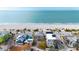 Aerial view of beach houses, the beach, and ocean at 1205 Gulf Way, St Pete Beach, FL 33706