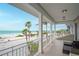 Ocean view balcony with seating area at 1205 Gulf Way, St Pete Beach, FL 33706