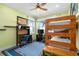 Bedroom with bunk beds, workspace, and ocean view at 1205 Gulf Way, St Pete Beach, FL 33706