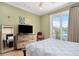 Bright bedroom with a queen-size bed, built-in dresser, and balcony access at 1205 Gulf Way, St Pete Beach, FL 33706