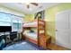 Bedroom with bunk beds, workspace, and ocean view at 1205 Gulf Way, St Pete Beach, FL 33706