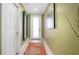 Bright entryway with light walls and coral rug at 1205 Gulf Way, St Pete Beach, FL 33706